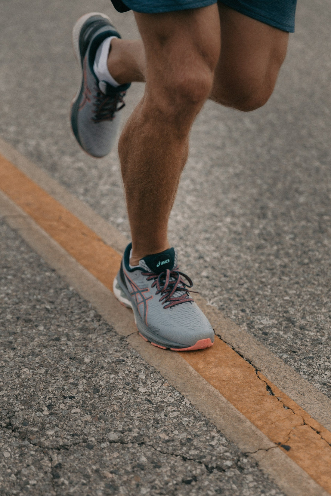 Runner's feet in motion showing repetitive impact and friction during long distance run